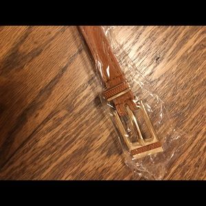 Brown color faux leather belt with golden material